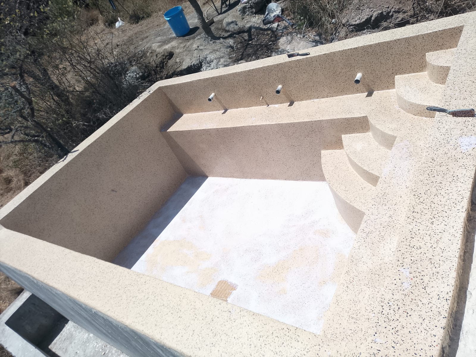 Terrazzo finished infinity swimming pool overlooking the landscape in Ngong
